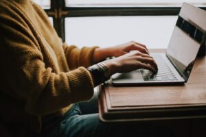 baby boomer sitting front of laptop